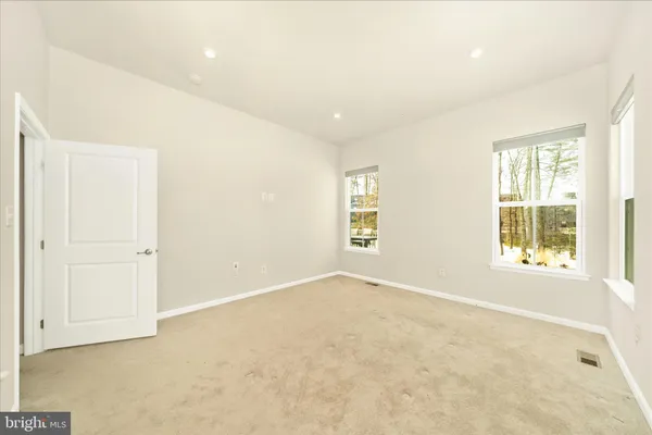 a spacious bathroom with a double vanity sink a toilet and a mirror