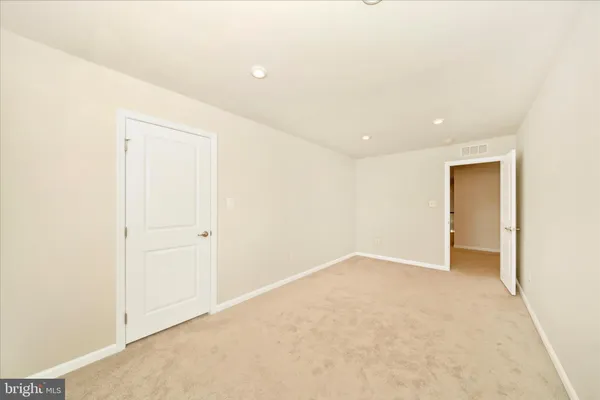 a kitchen with granite countertop a refrigerator and a stove top oven