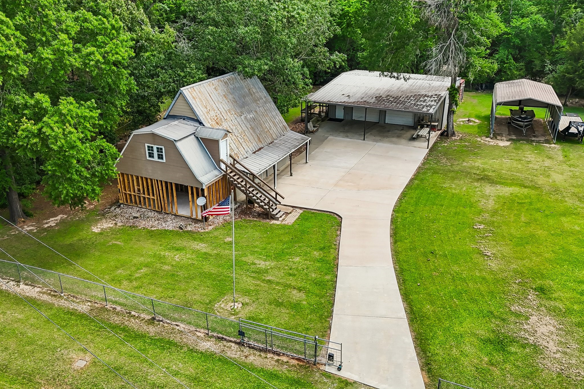 164 Frank Road Trinity, TX 75862 - Photo 2 of 20 This bird’s-eye perspective showcases the gated entrance and generous acreage, offering a private retreat with plenty of room for vehicles, equipment, and future development.