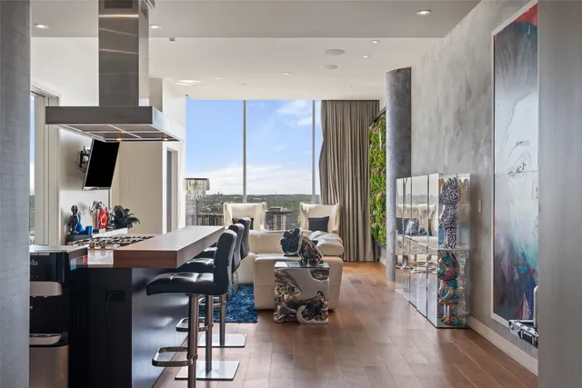 a living room with furniture and large windows