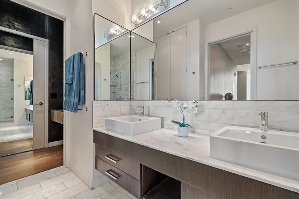 a bathroom with double sink and a mirror