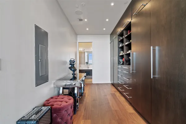 a hallway with furniture and wooden floor