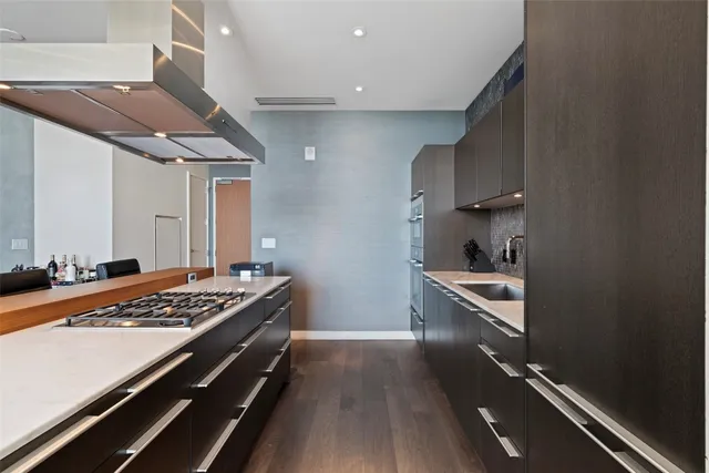 a kitchen with wooden cabinets and a stove top oven