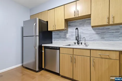 a kitchen with stainless steel appliances a refrigerator and a sink