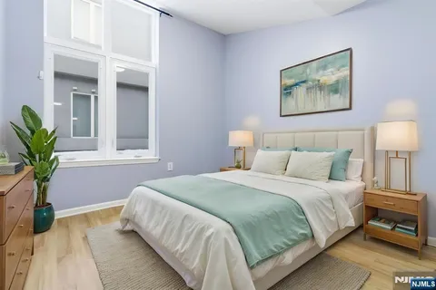 a bedroom with a bed and a potted plant