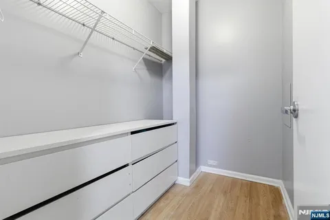 a view of walk in closet with empty racks