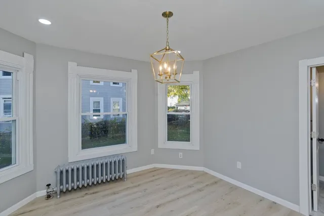 a view of an entryway with wooden floor