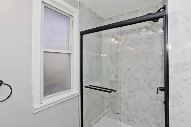 a bathroom with a glass shower door