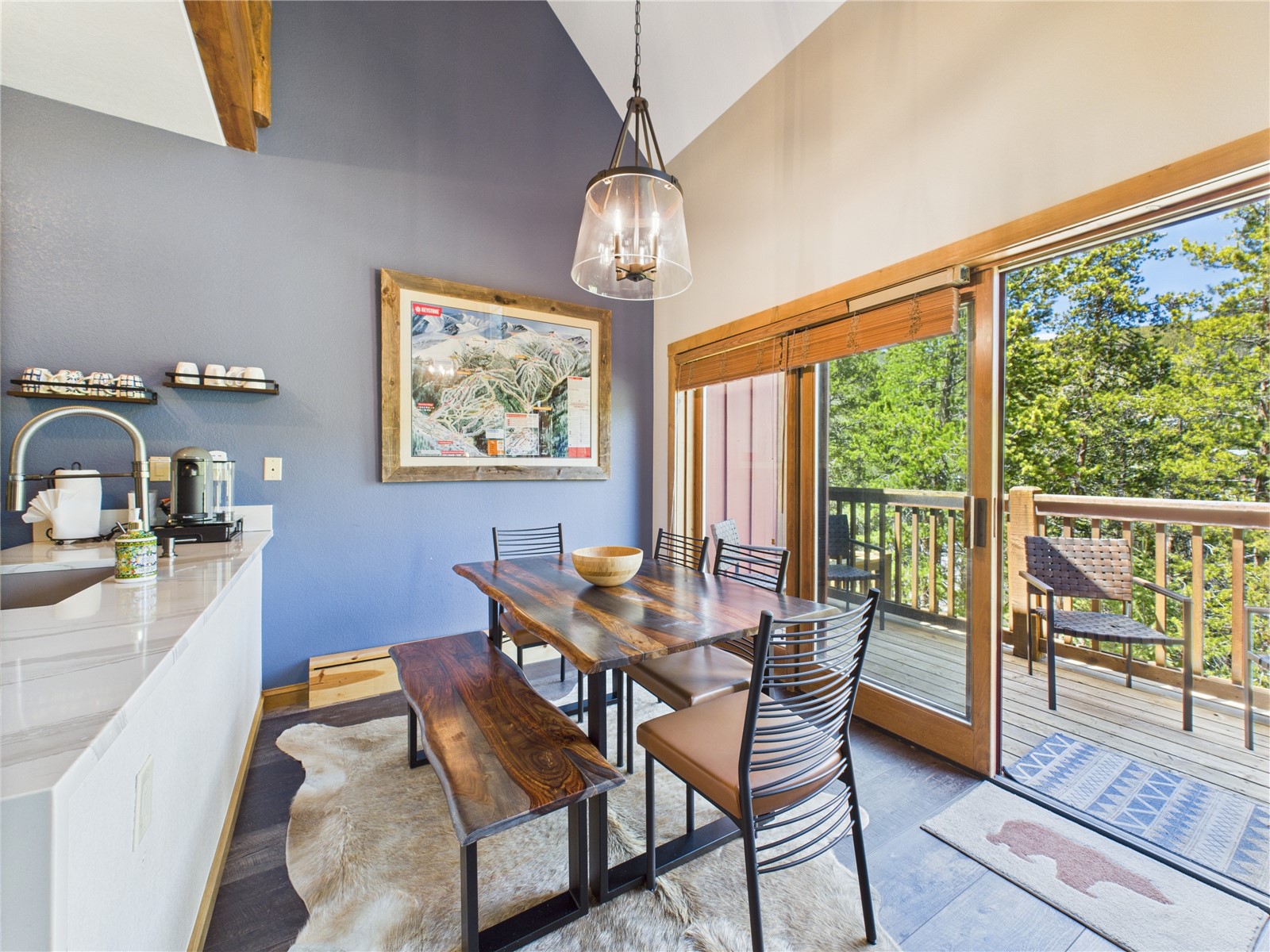 27 Lake Ridge Circle, Unit 1842 Keystone, CO 80435 - Photo 13 of 50 Rustic wood table with seating for six, framed by vaulted ceilings and large sliding doors to the forest-view deck.