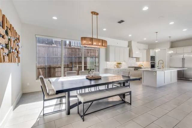 a living room with furniture a table and kitchen view