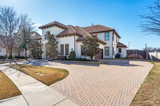 a view of a white house with a swimming pool