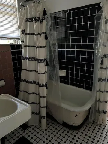 a bathroom with a bathtub and shower