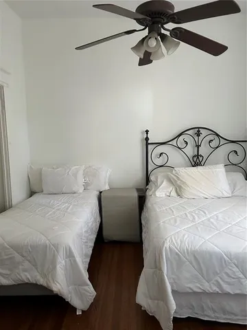 a bedroom with a bed and ceiling fan