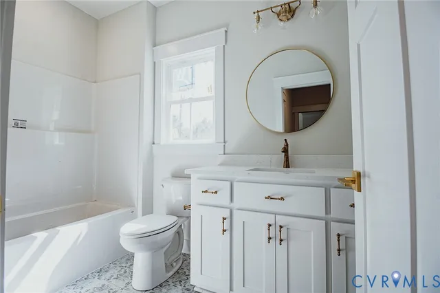 a bathroom with a toilet a sink and a mirror