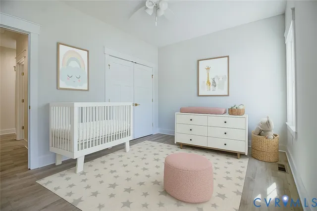 a room with a baby crib and dresser