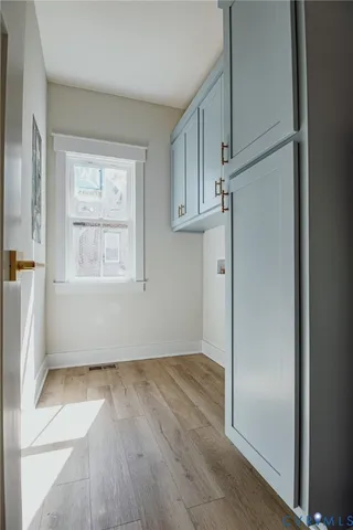 an empty room with wooden floor and a window
