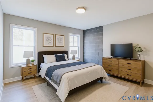 a bedroom with a bed and flat screen tv