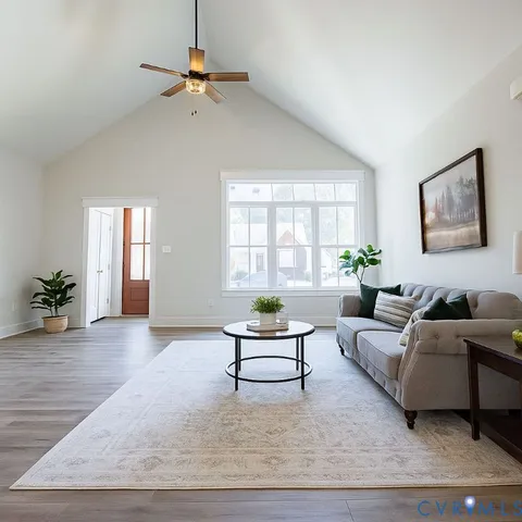 a living room with furniture window and wooden floor