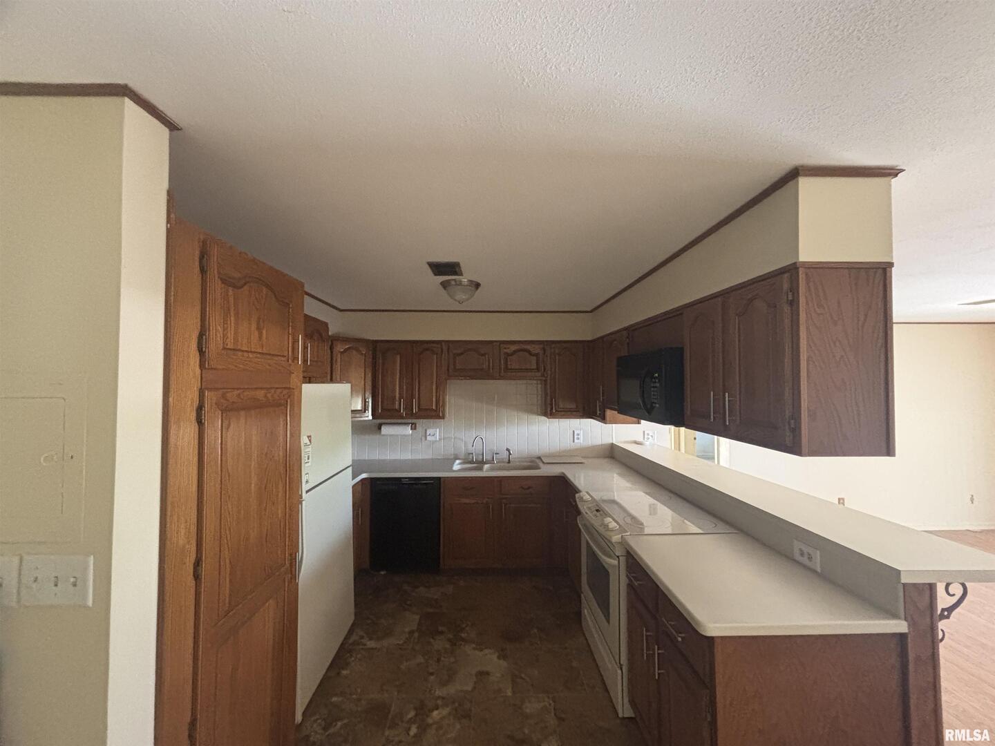920 17th Street, Unit 28 Moline, IL 61265 - Photo 8 of 17 a kitchen with stainless steel appliances granite countertop a sink and refrigerator