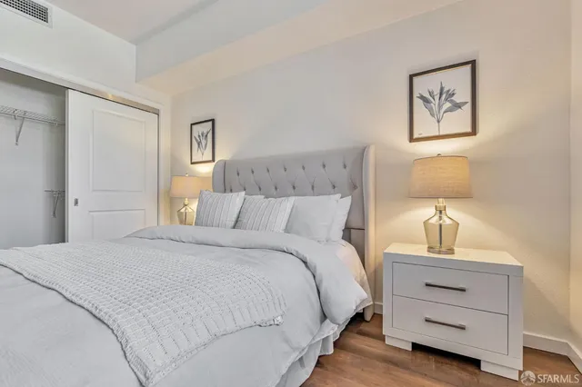 a bedroom with a bed and lamp