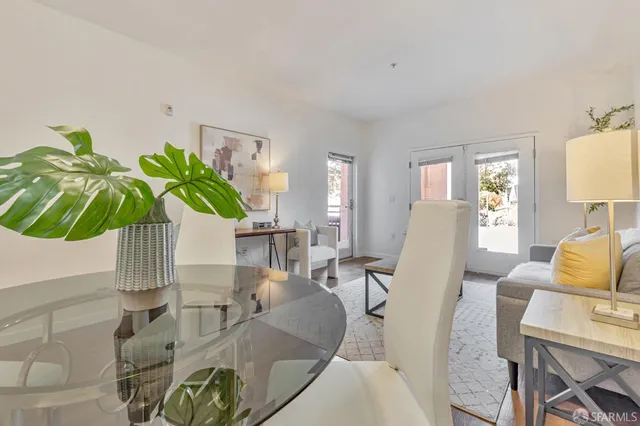 a living room with furniture potted plant and a large window