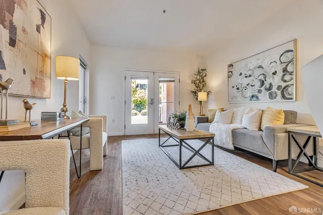 a living room with furniture and a wooden floor