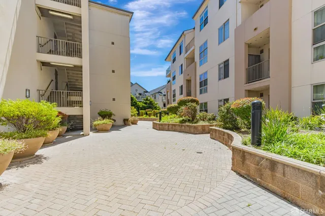 a view of a swimming pool with a yard and furniture