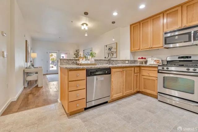 a kitchen with a stove top oven sink and cabinets