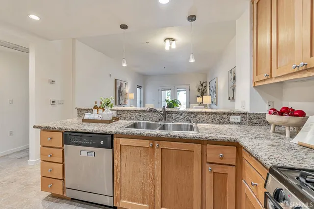 a kitchen with granite countertop kitchen island white cabinets and white appliances