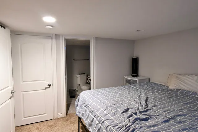 a bedroom with a bed and a mirror