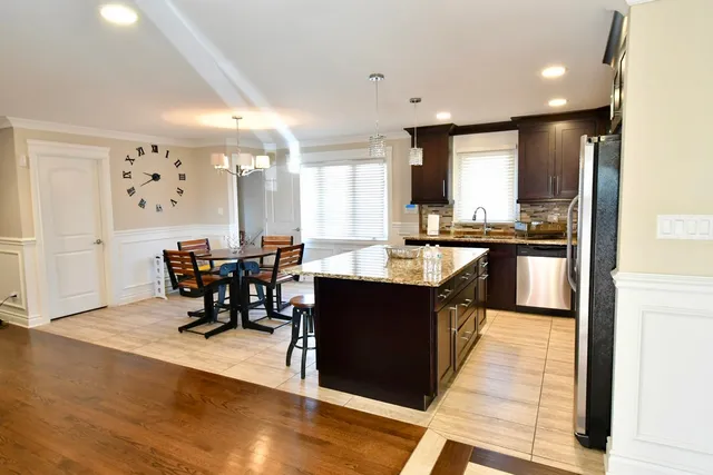 a large kitchen with lots of counter top space and stainless steel appliances