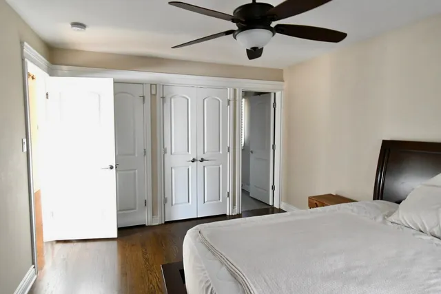 a bedroom with a large bed and a chandelier