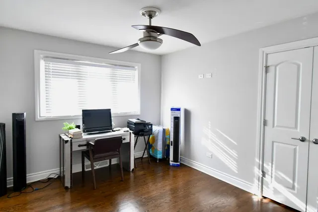 a view of a workspace with furniture and a window