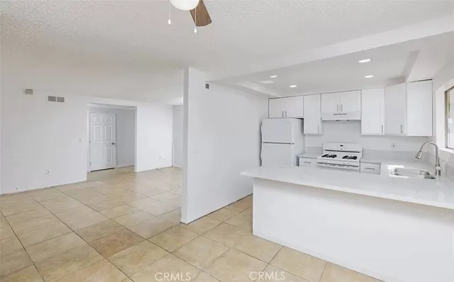 a kitchen with stainless steel appliances granite countertop a sink and cabinets