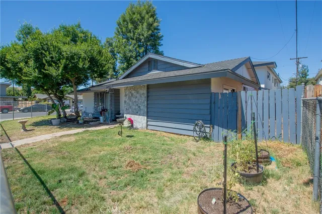 a backyard of a house with yard and outdoor seating