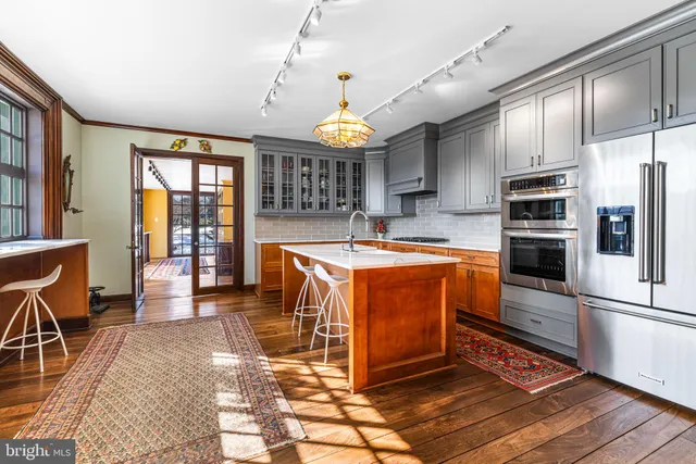 a hallway with a large window and a rug