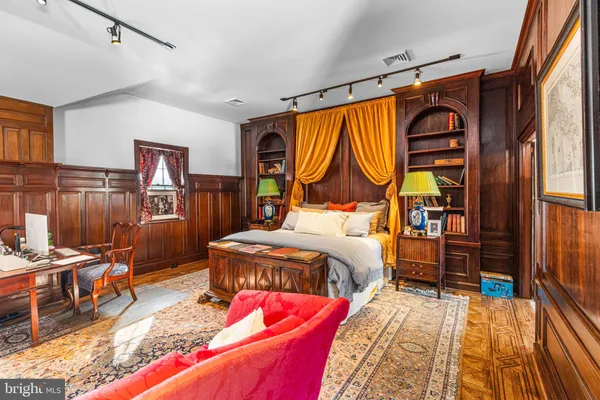 a living room with furniture a rug and a chandelier