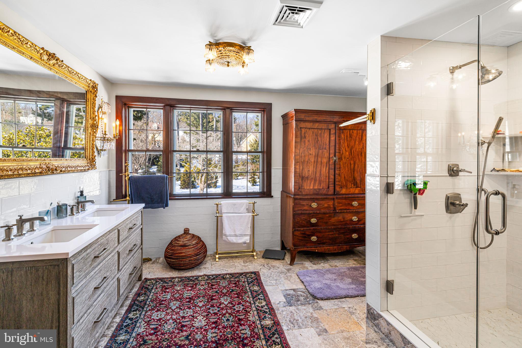 1260 County Line Road Wayne, PA 19087 - Photo 32 of 64 a bathroom with a granite countertop sink a mirror and shower