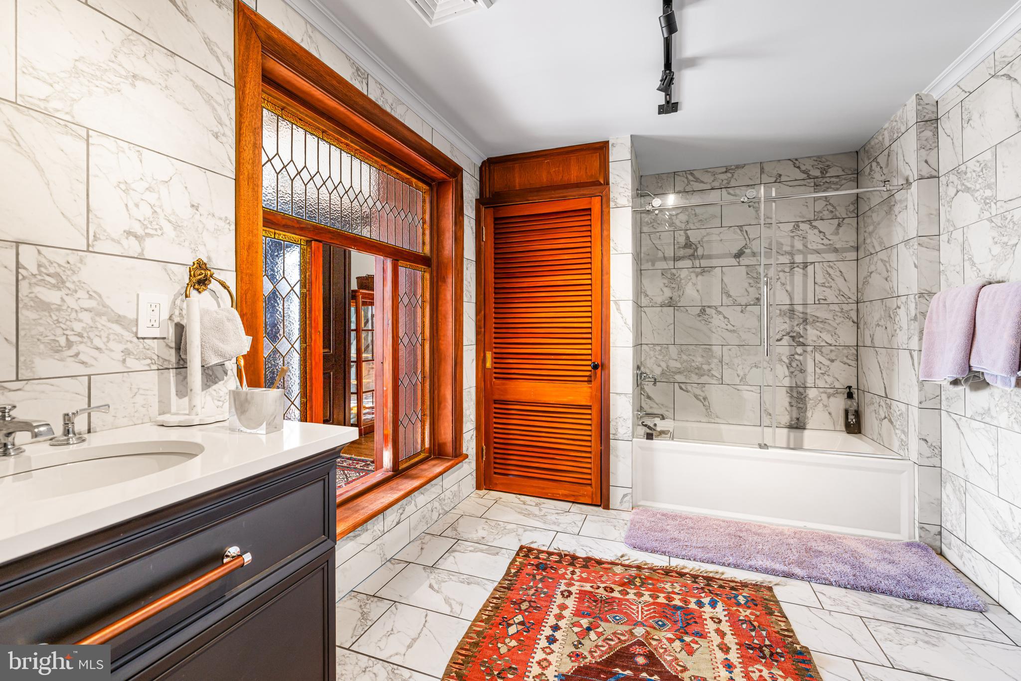 1260 County Line Road Wayne, PA 19087 - Photo 48 of 64 a bathroom with a sink a mirror and a bathtub