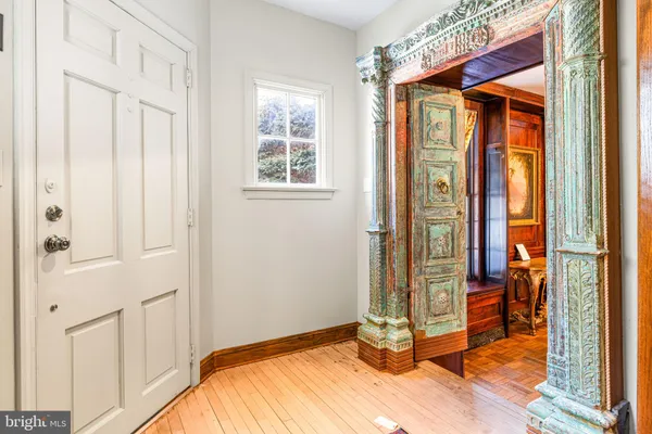 a living room filled with furniture windows and a chandelier