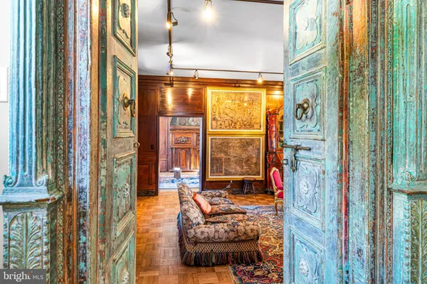 a living room filled with furniture and a chandelier