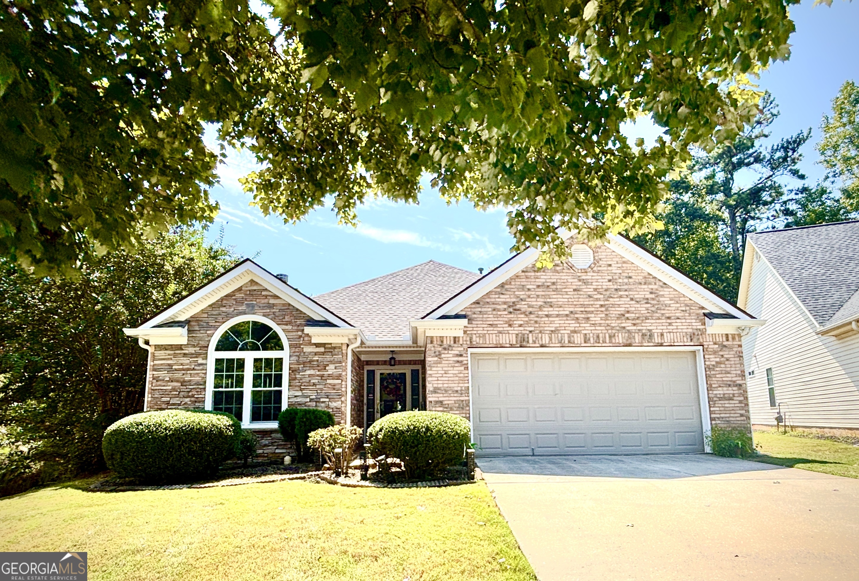 1102 Strath Clyde Way McDonough, GA 30253 - Photo 2 of 23 a front view of a house with a yard and garage