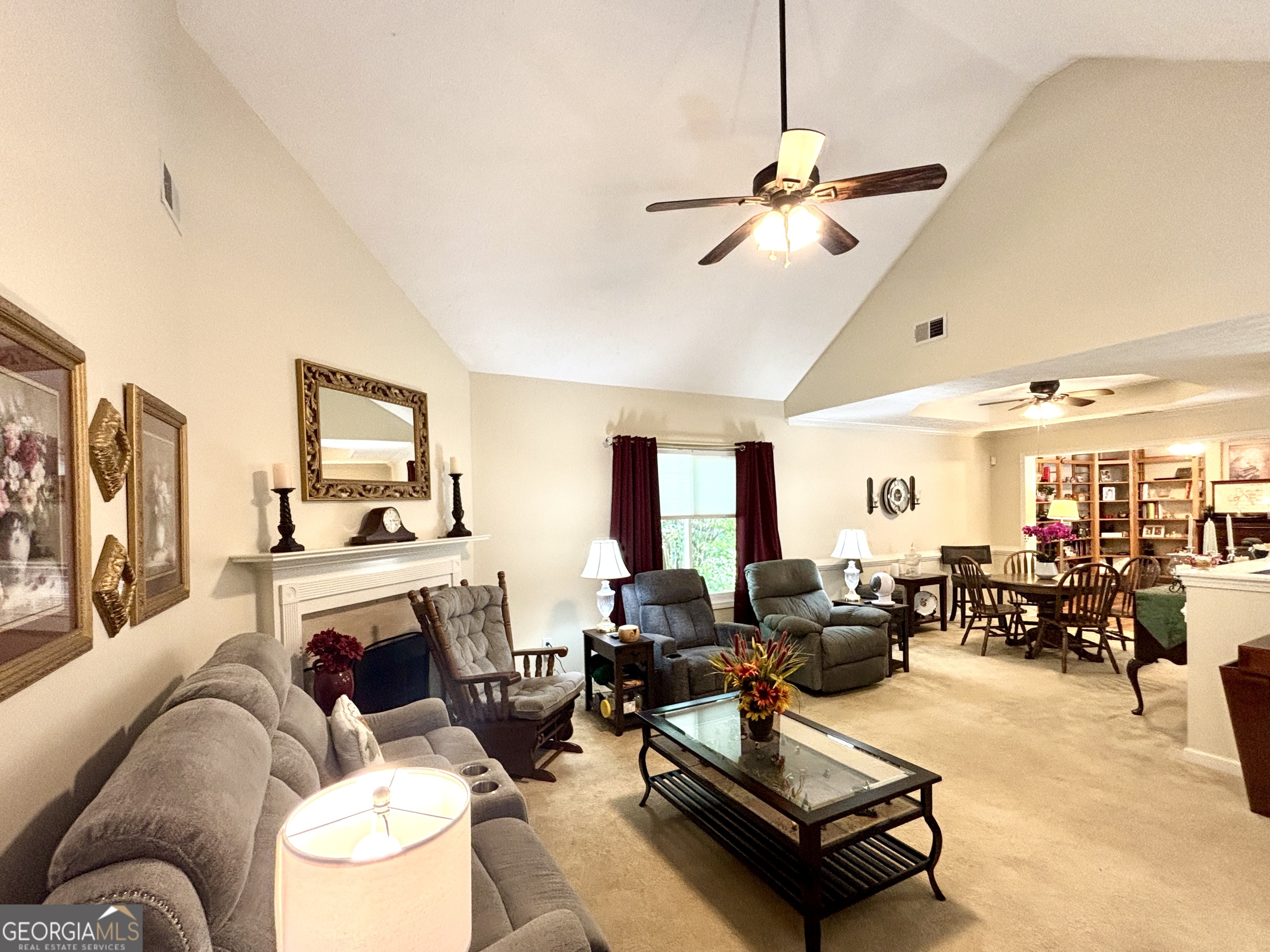 1102 Strath Clyde Way McDonough, GA 30253 - Photo 6 of 23 a living room with furniture a fireplace and a flat screen tv