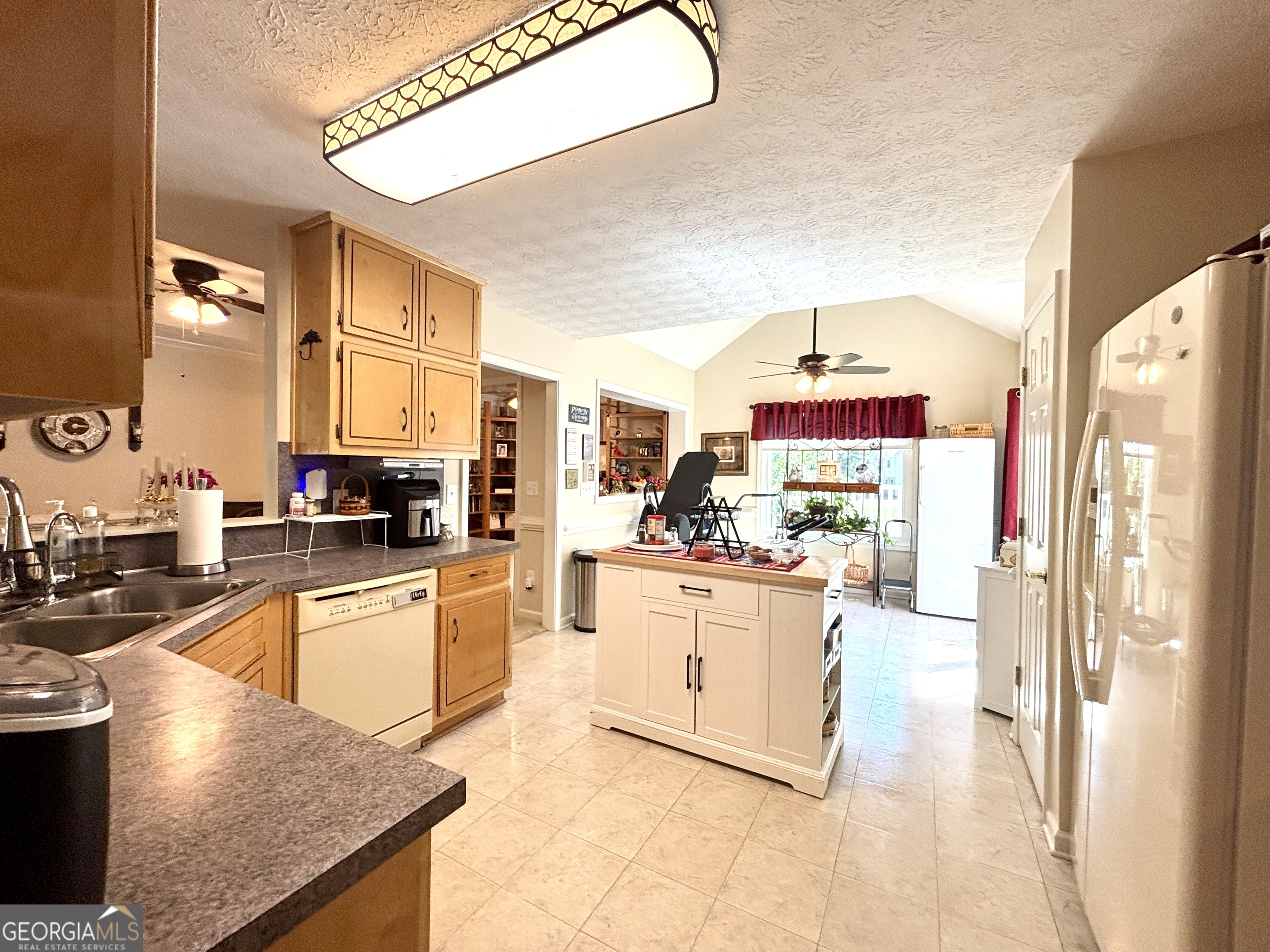 1102 Strath Clyde Way McDonough, GA 30253 - Photo 10 of 23 a kitchen with stainless steel appliances granite countertop a refrigerator a stove and a sink with couches