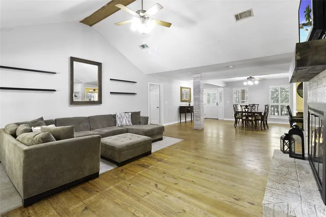 a living room with furniture and wooden floor