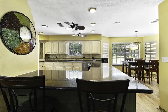 a kitchen with stainless steel appliances granite countertop a sink and a refrigerator