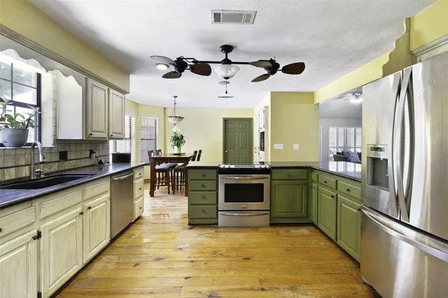 a kitchen with granite countertop white cabinets and white appliances