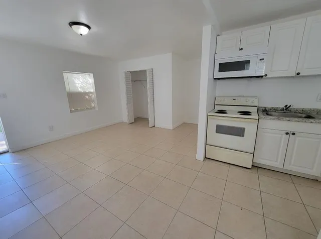 a kitchen with cabinets and appliances