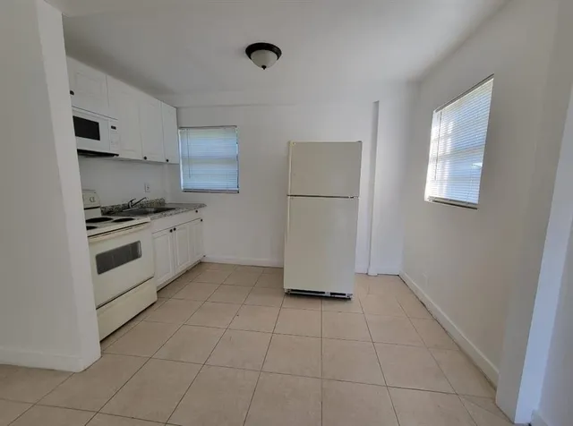 a kitchen with cabinets and white appliances