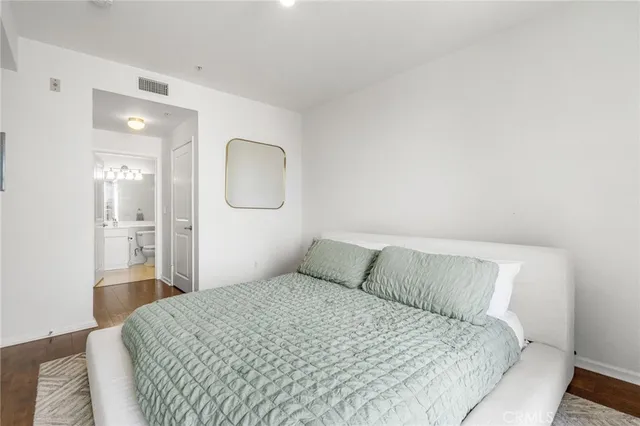 a bedroom with a bed and a mirror